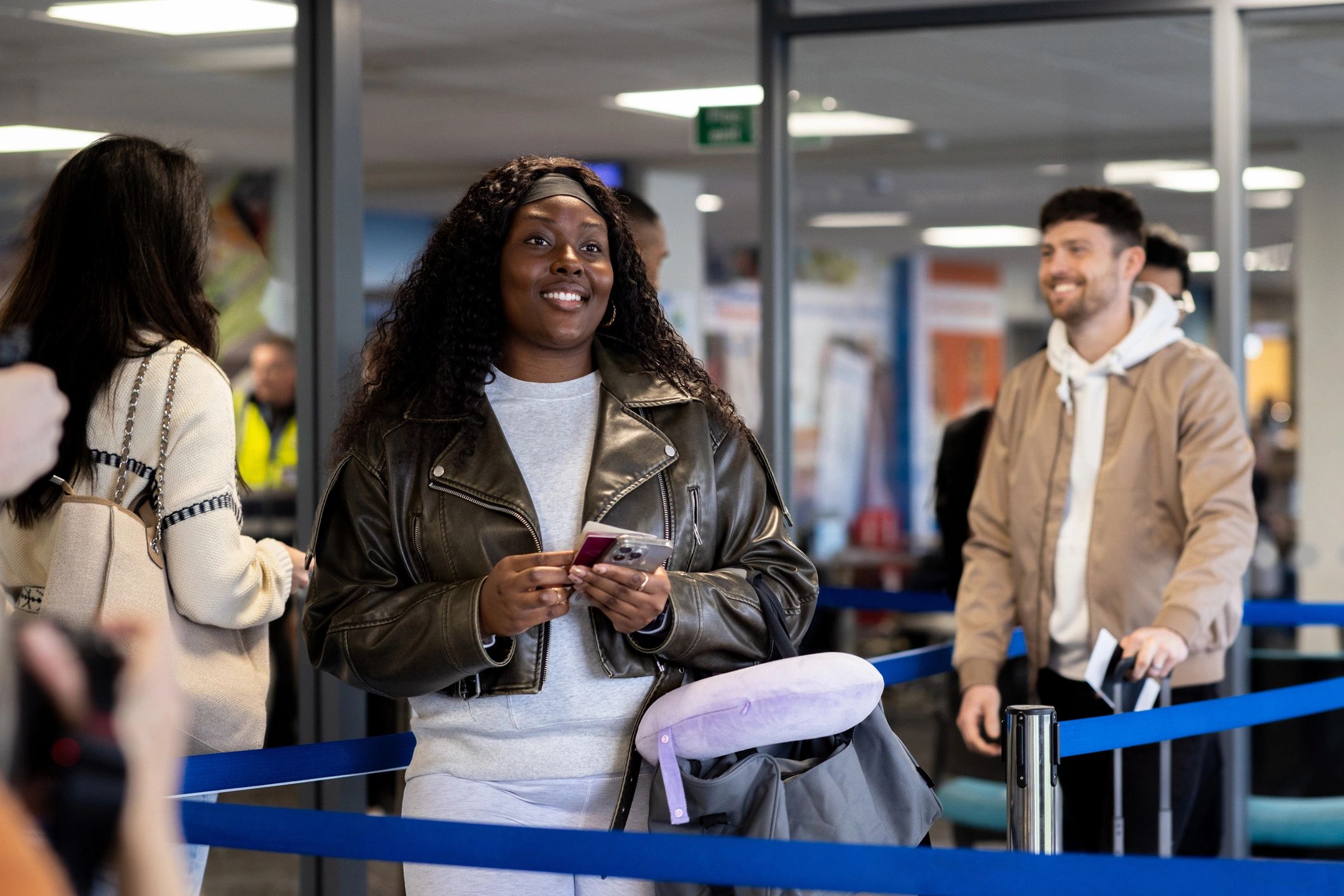 Passengers lining up at an airport check-in desk