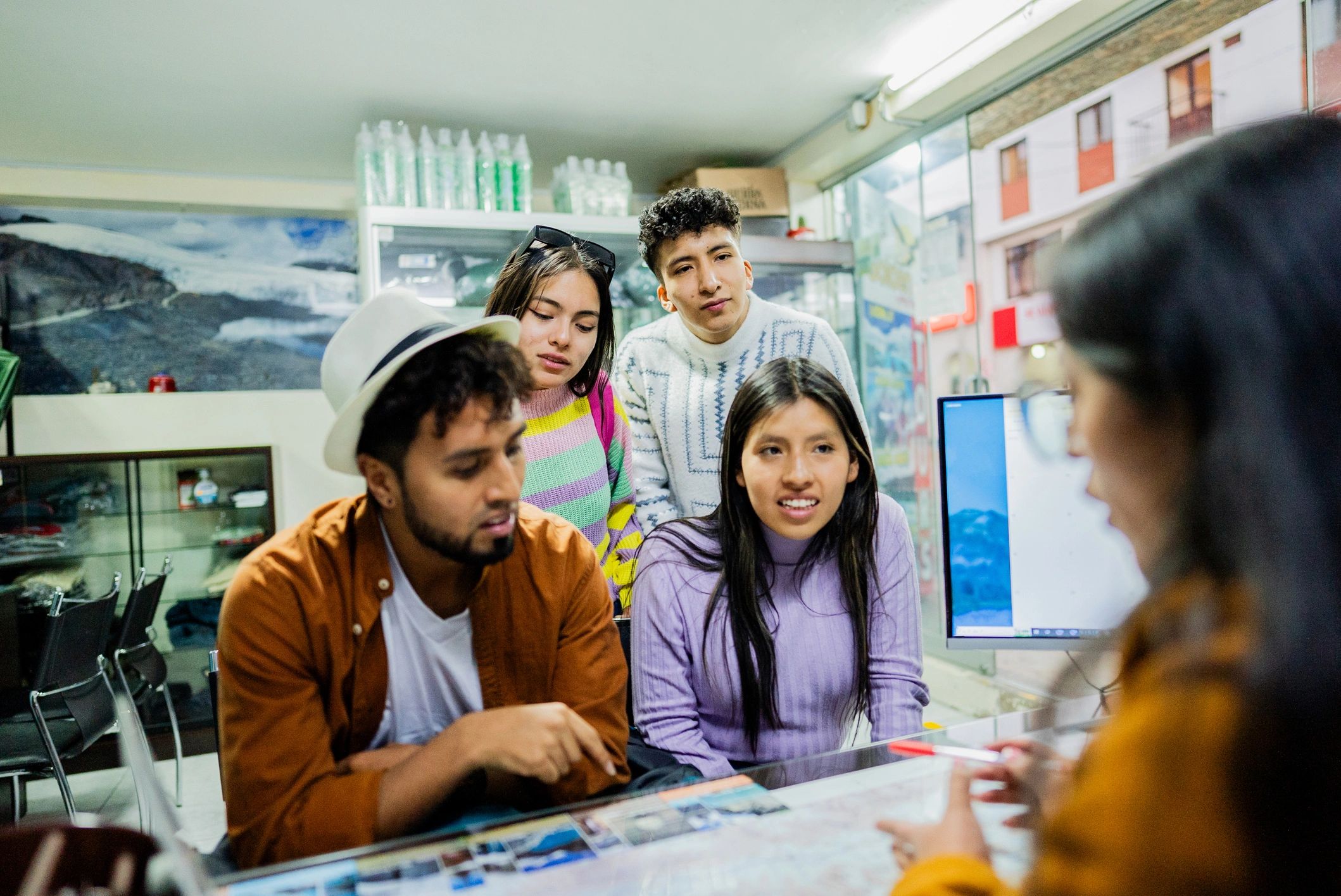 Travel agent assisting customers in a travel agency