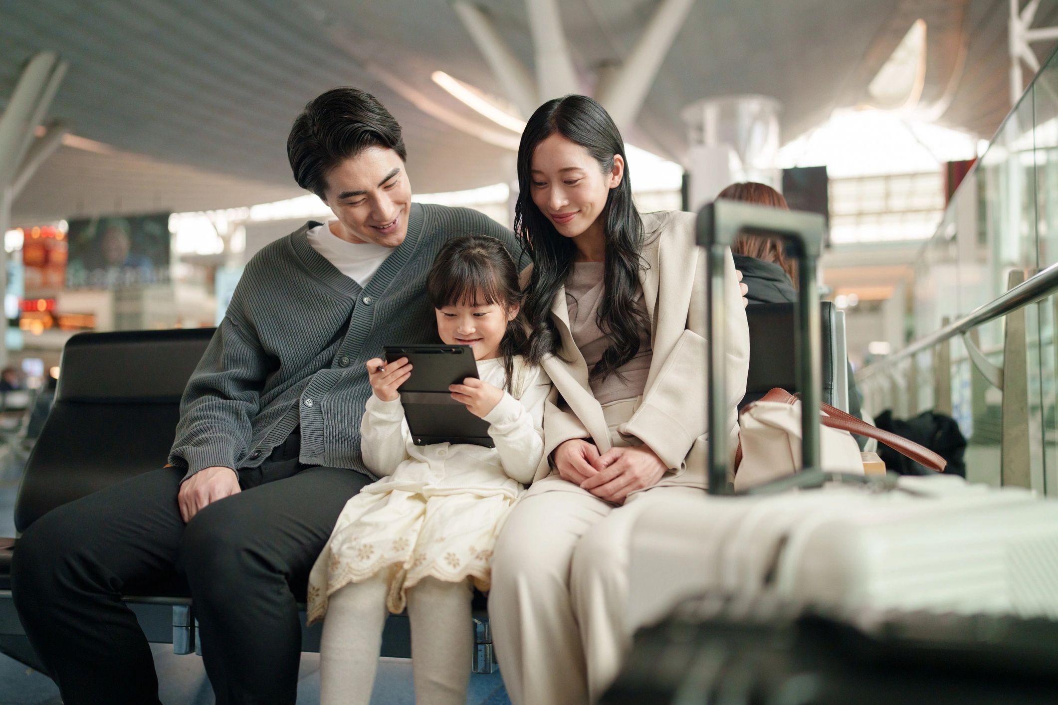 Family waiting at an airport, representing flight planning