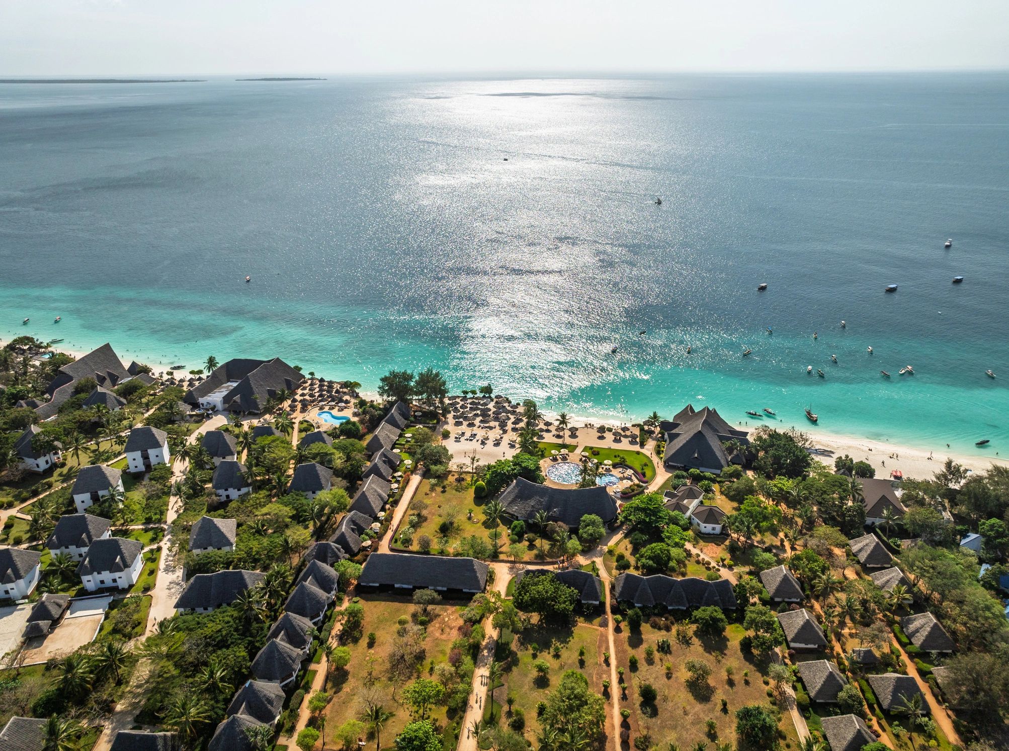 Beachfront resort bungalows along turquoise water